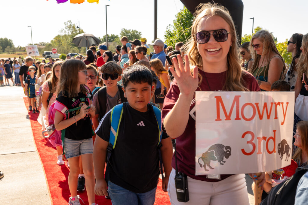First day of school red carpet celebration picture including teachers, students and parents.